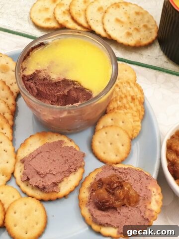 A dish of chicken liver pate with biscuits.