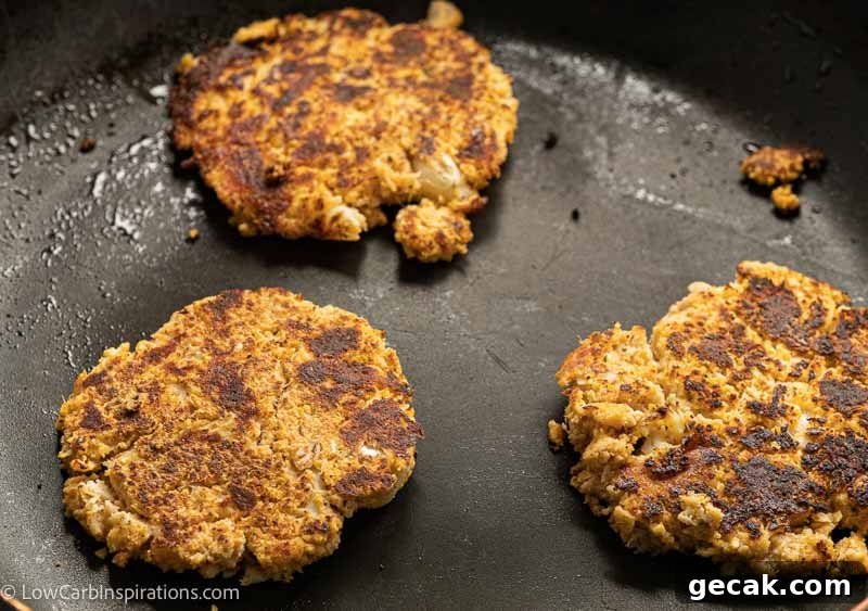 Savory Cauliflower Pancakes with Herbs and Parmesan 9 cauliflower savory pancakes in a skillet cooking