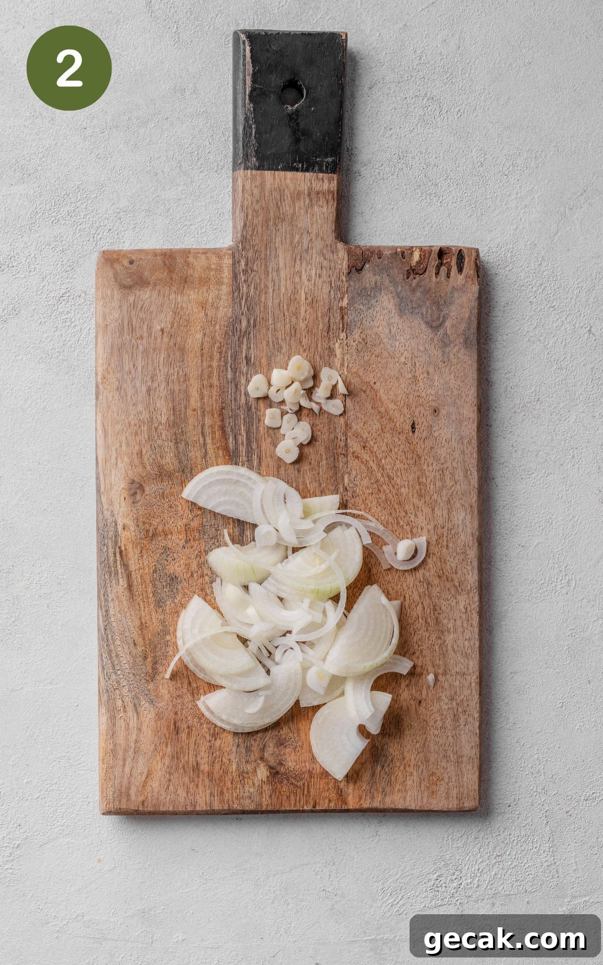 Creamy Chicken & Mushroom Pie Recipe for Home Baking 5 sliced onions and garlic on a cutting board.
