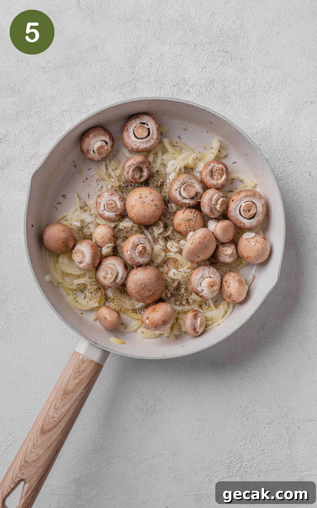 Creamy Chicken & Mushroom Pie Recipe for Home Baking 8 mushroooms and thyme in a skillet.