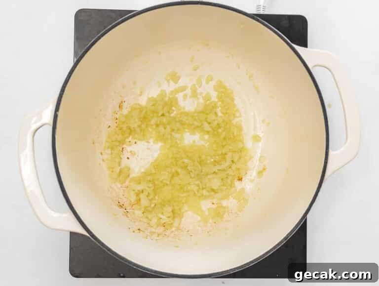 onions and garlic frying in a Dutch oven