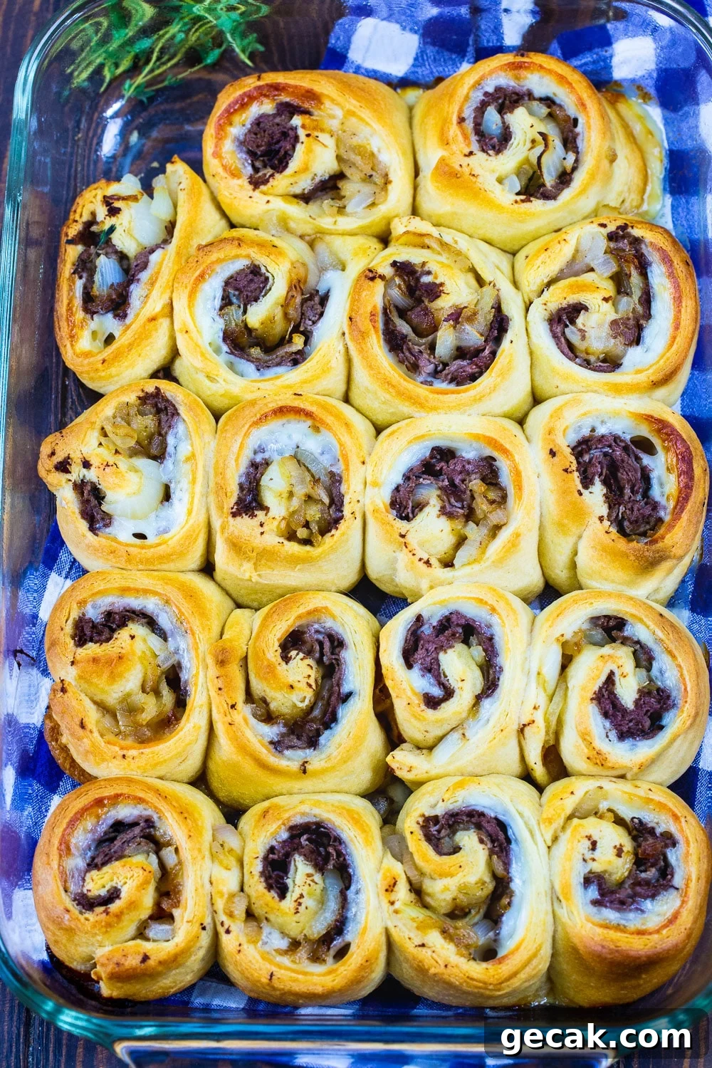 French Dip Pinwheels Recipe — Savory Roast Beef Appetizer 3 Pinwheels in a baking dish.