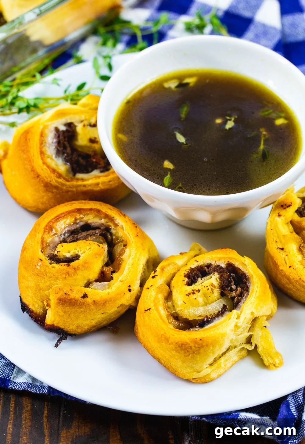 French Dip Pinwheels Recipe — Savory Roast Beef Appetizer 5 French Dip Pinwheels on a plate with Au Jus.