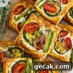 Savory Puff Pastry Vegetable Tarts for Entertaining 11 Puff pastry vegetable tarts with herbed goat cheese, cherry tomatoes, asparagus, shallots, and zucchini.