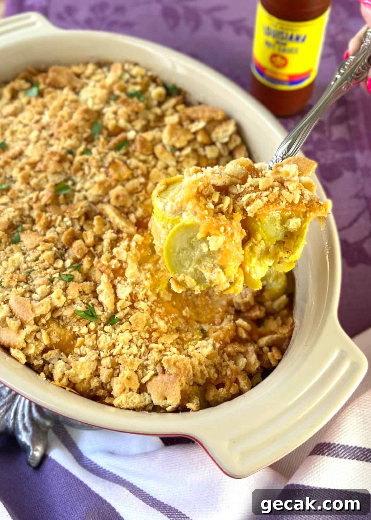 Cajun Squash Casserole with Cheesy Breadcrumb Topping 2 Squash casserole in baking dish.