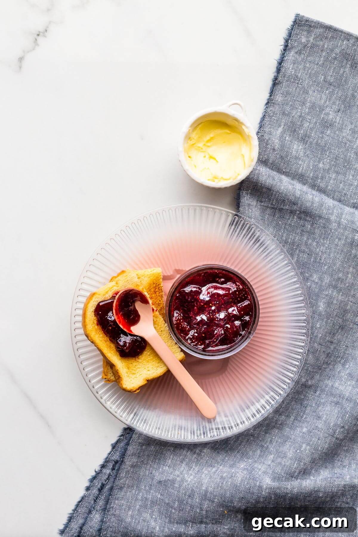 Jar of strawberry jam with toast.
