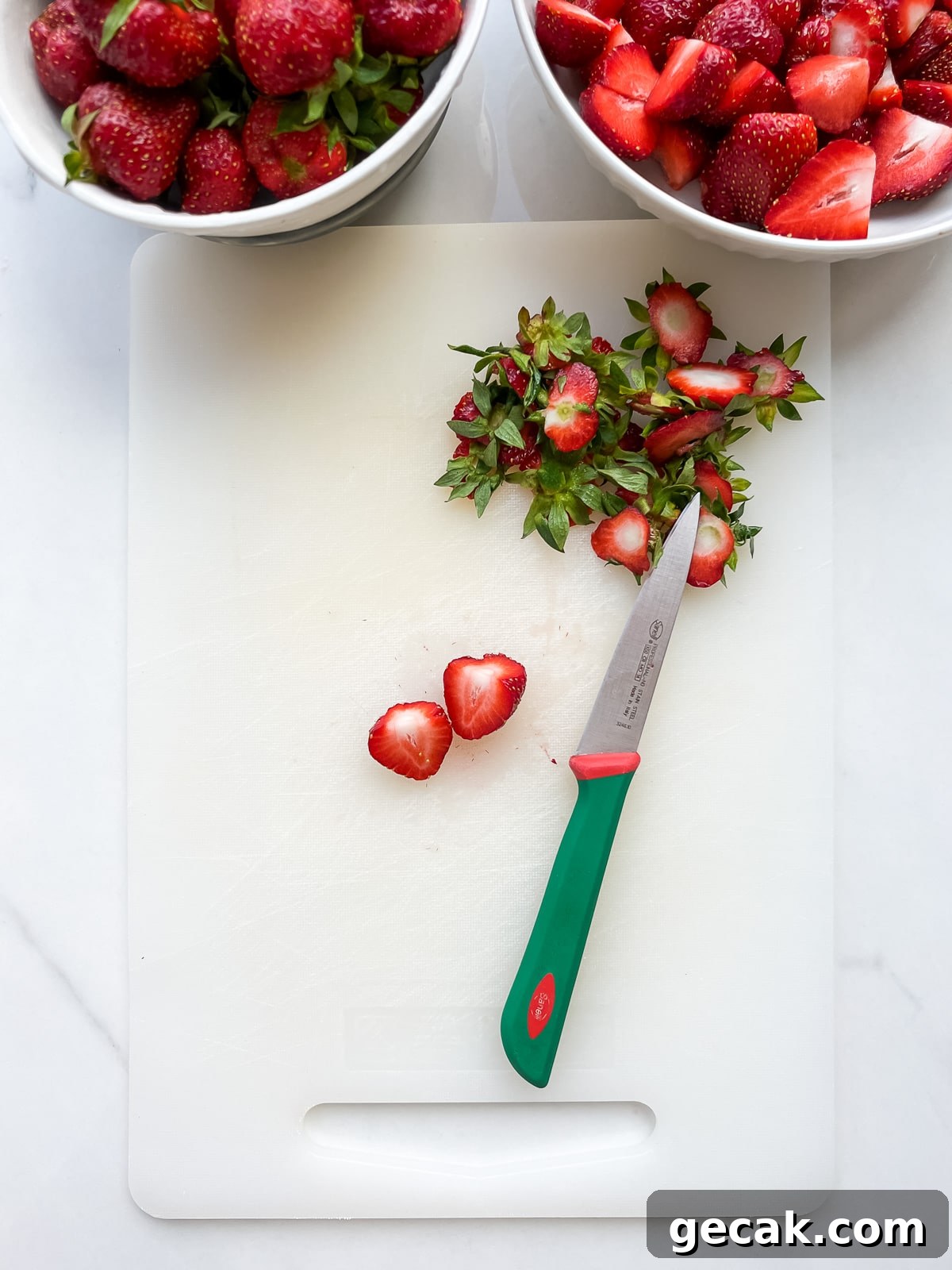 Hulling and chopping strawberries.