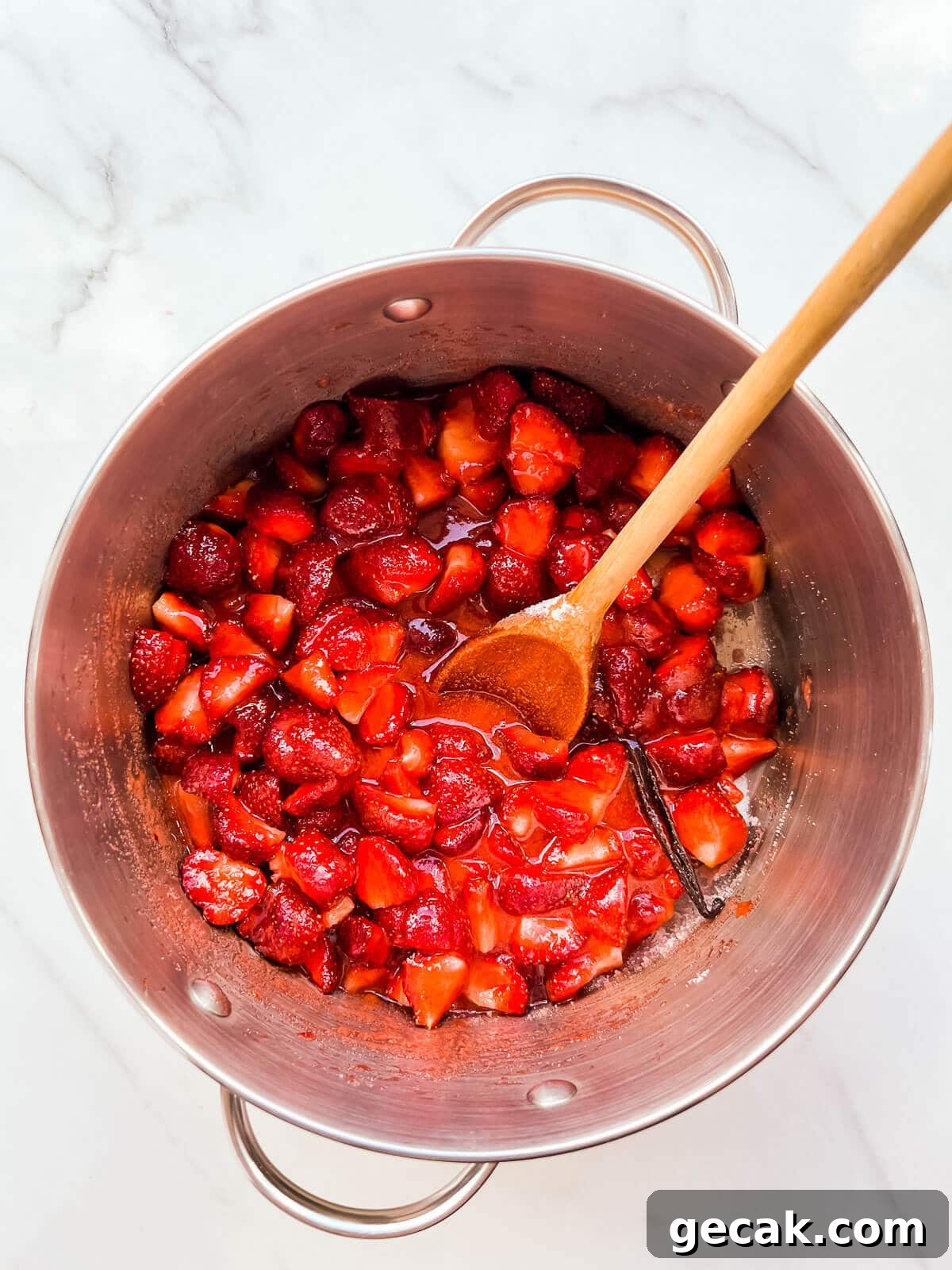 Strawberries macerating in sugar with lemon and vanilla.