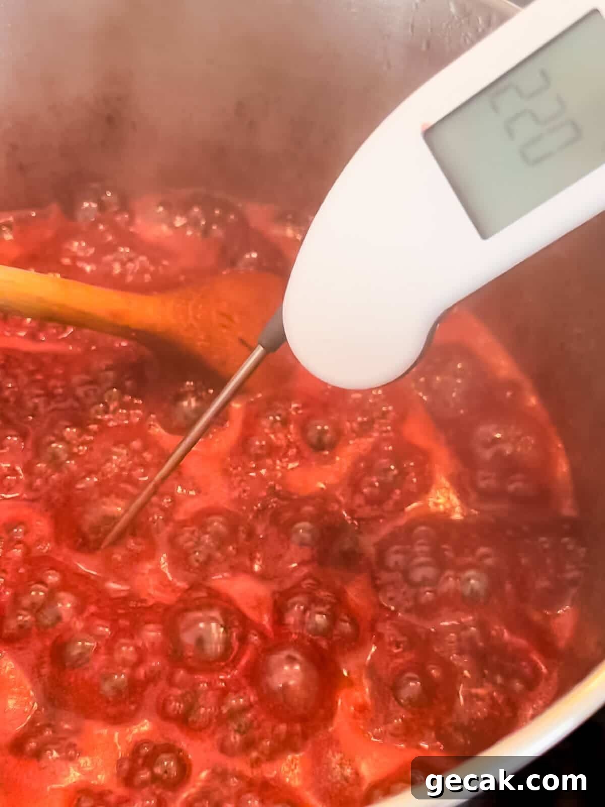 Boiling jam close to setting point with large bubbles.