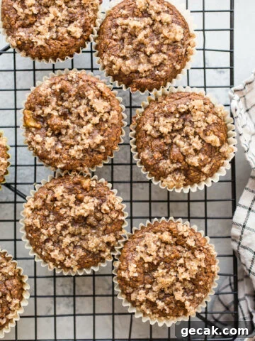 Apple muffins on a black wire rack.