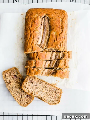 Sliced banana bread on parchment paper.