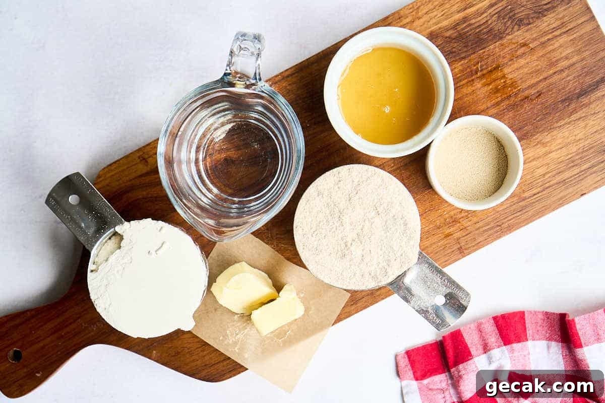 water, honey, wheat flour, white flour, and butter on wooden board