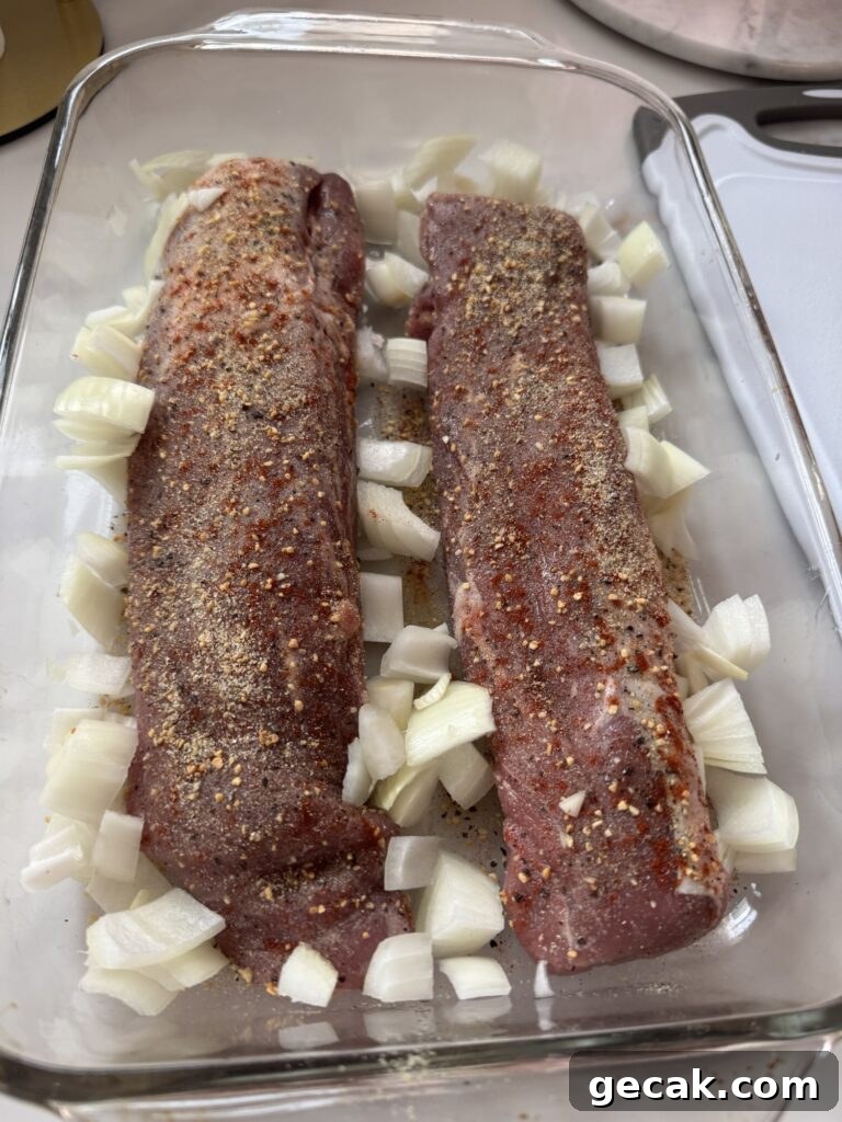 Seasoned raw tenderloins with onions