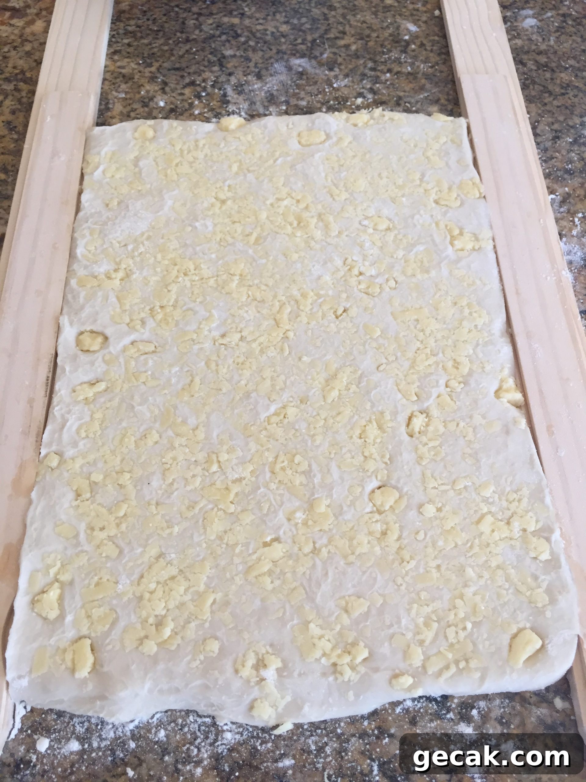 Roll dough until it reaches the height of the paint stick.
