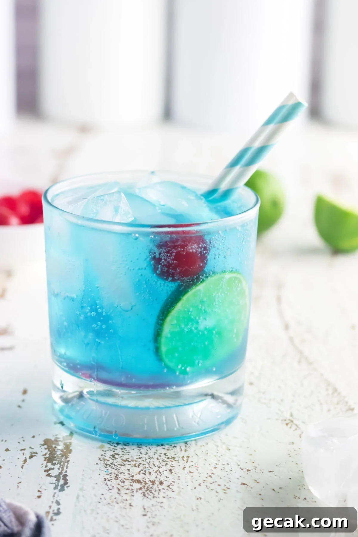 Side view of this cocktail with a blue and white straw.
