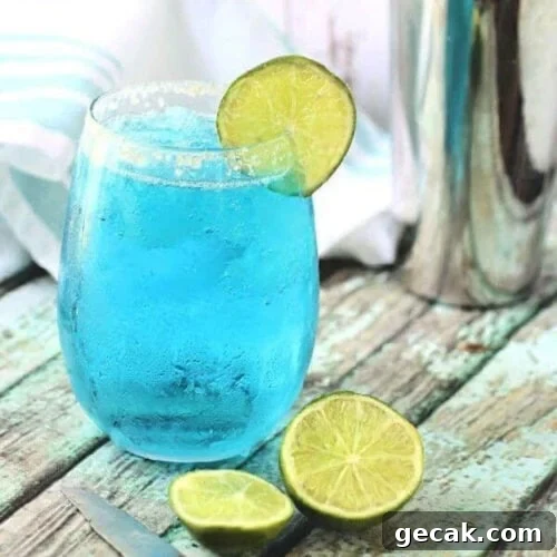Blue cocktail with a lime garnish for feature image.