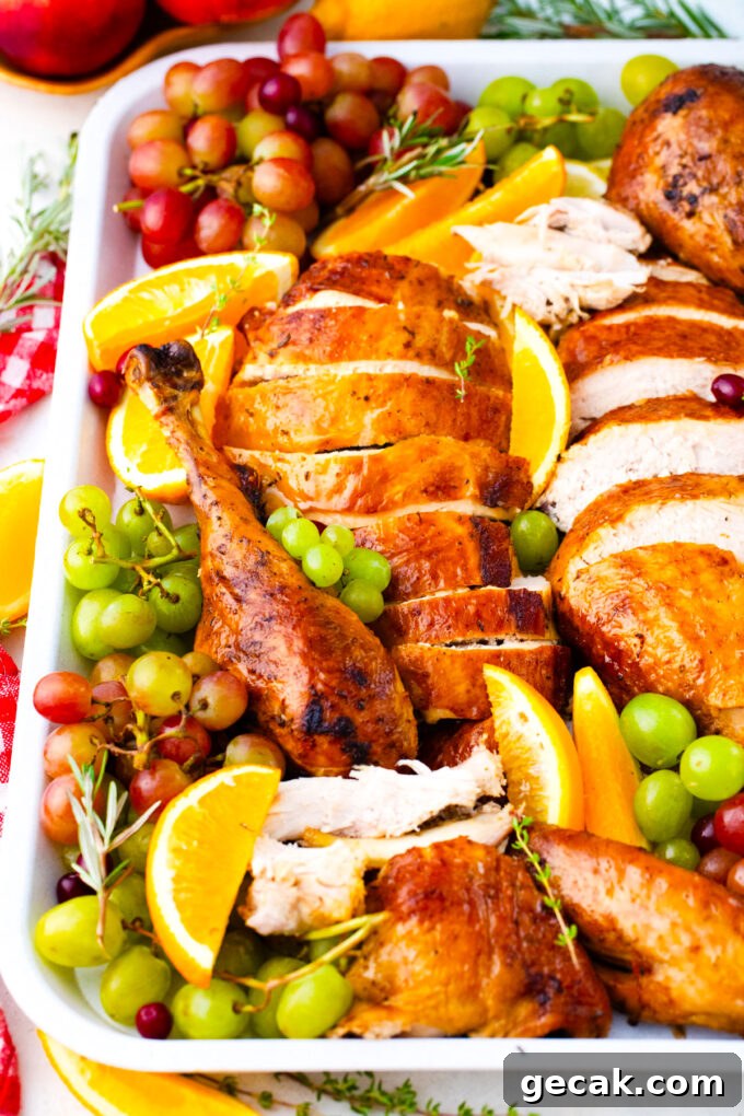 Sliced, juicy oven roasted turkey on a serving platter.
