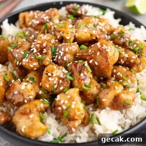 honey garlic chicken over white rice in a bowl