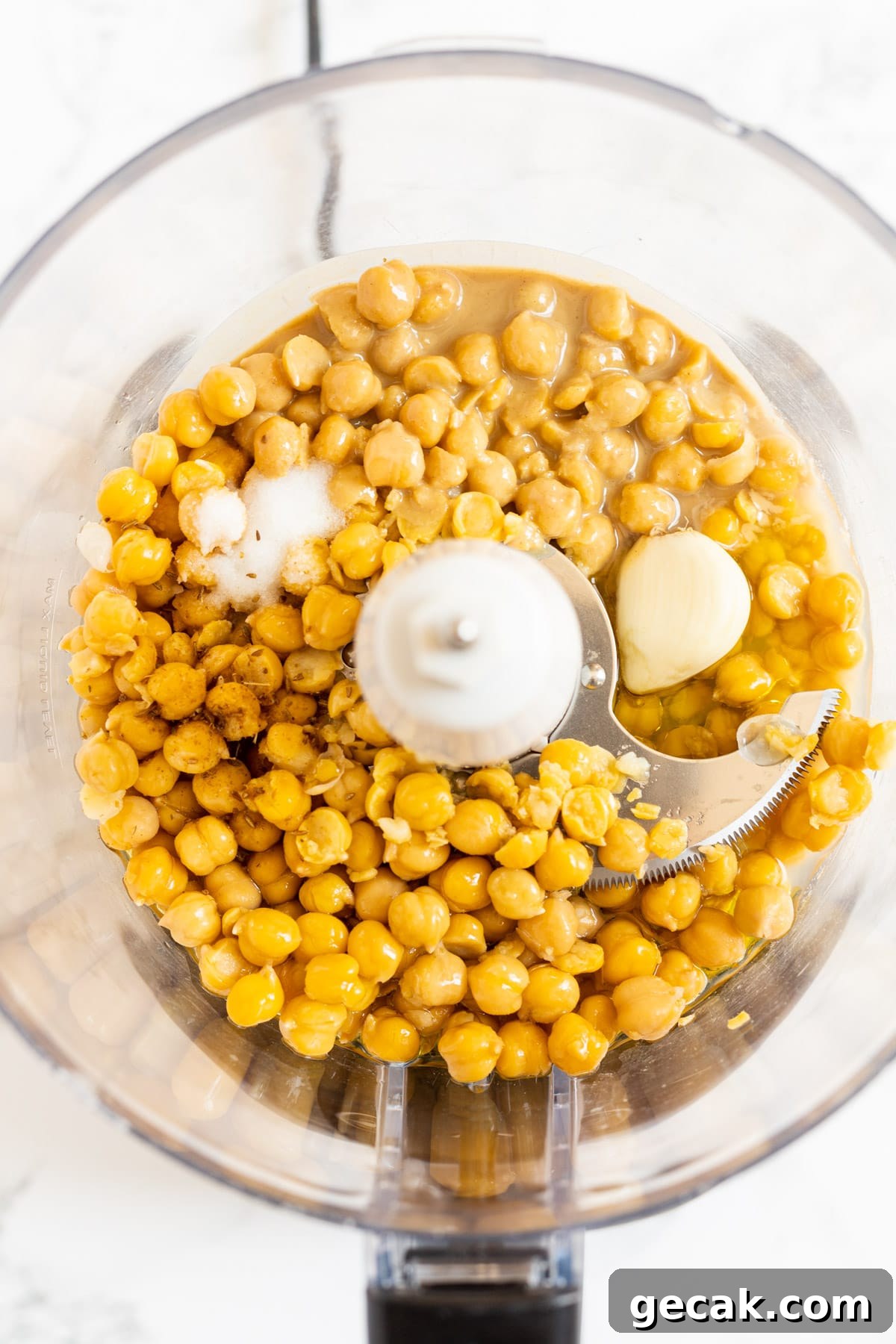 Creamy Chickpea Hummus Recipe: Classic Homemade Dip 6 Chickpea hummus ingredients in a food processor.