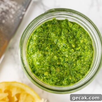 a close up view of kale pesto in a mason jar.