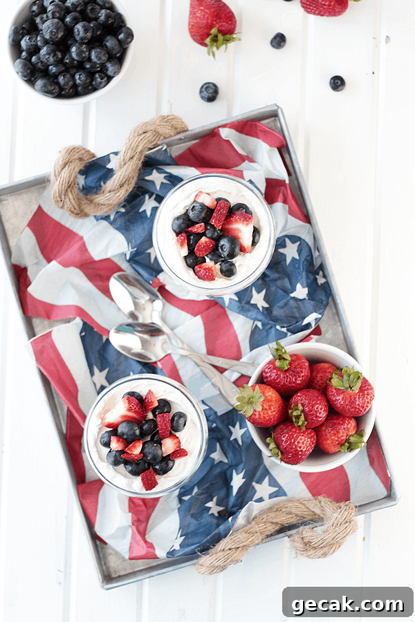 No-Bake Berry Cheesecake Parfait Recipe with Layered Berries 4 an overhead shot of an american flag in a serving platter with bowls of cheesecake parfait and fresh berries on it