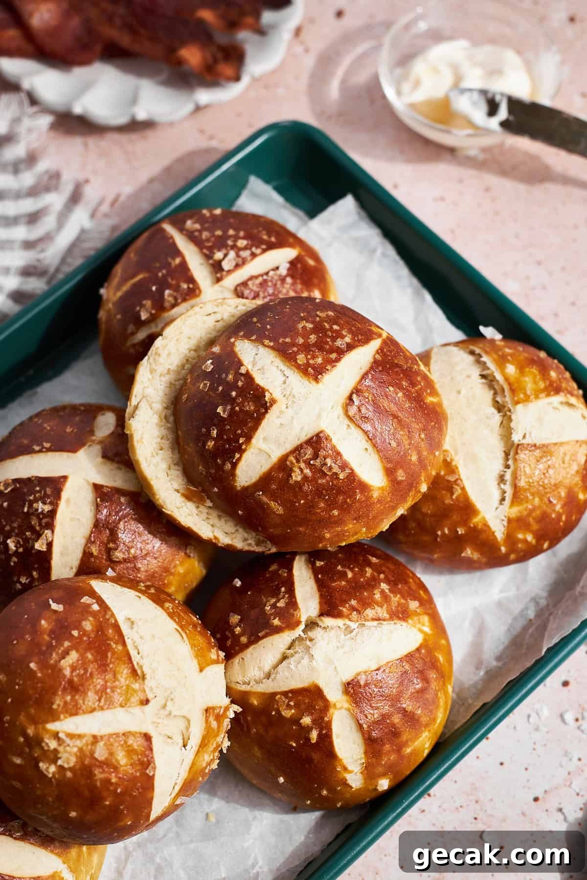 Sourdough Discard Pretzel Buns in a pile on a green tray. 