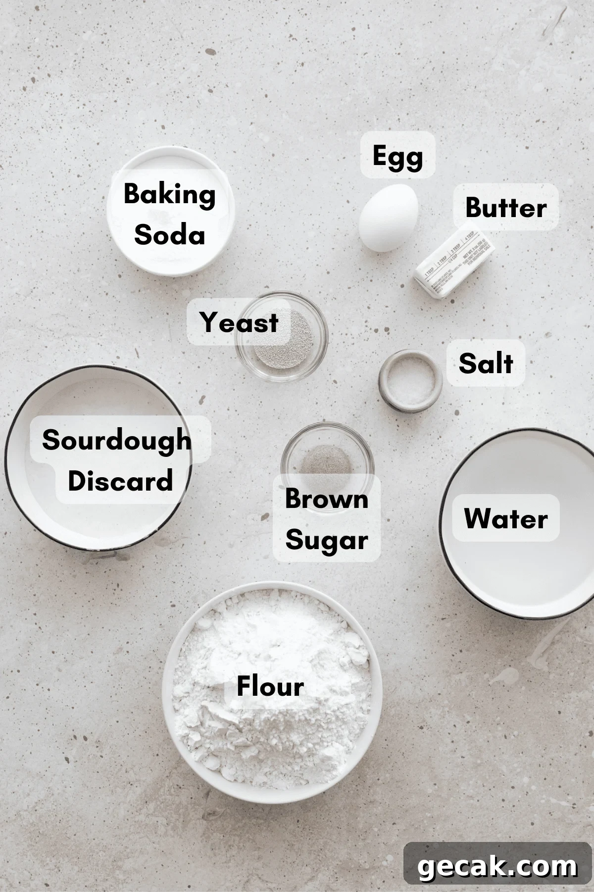 Ingredients for Sourdough Discard Pretzel Buns in small white bowls. 