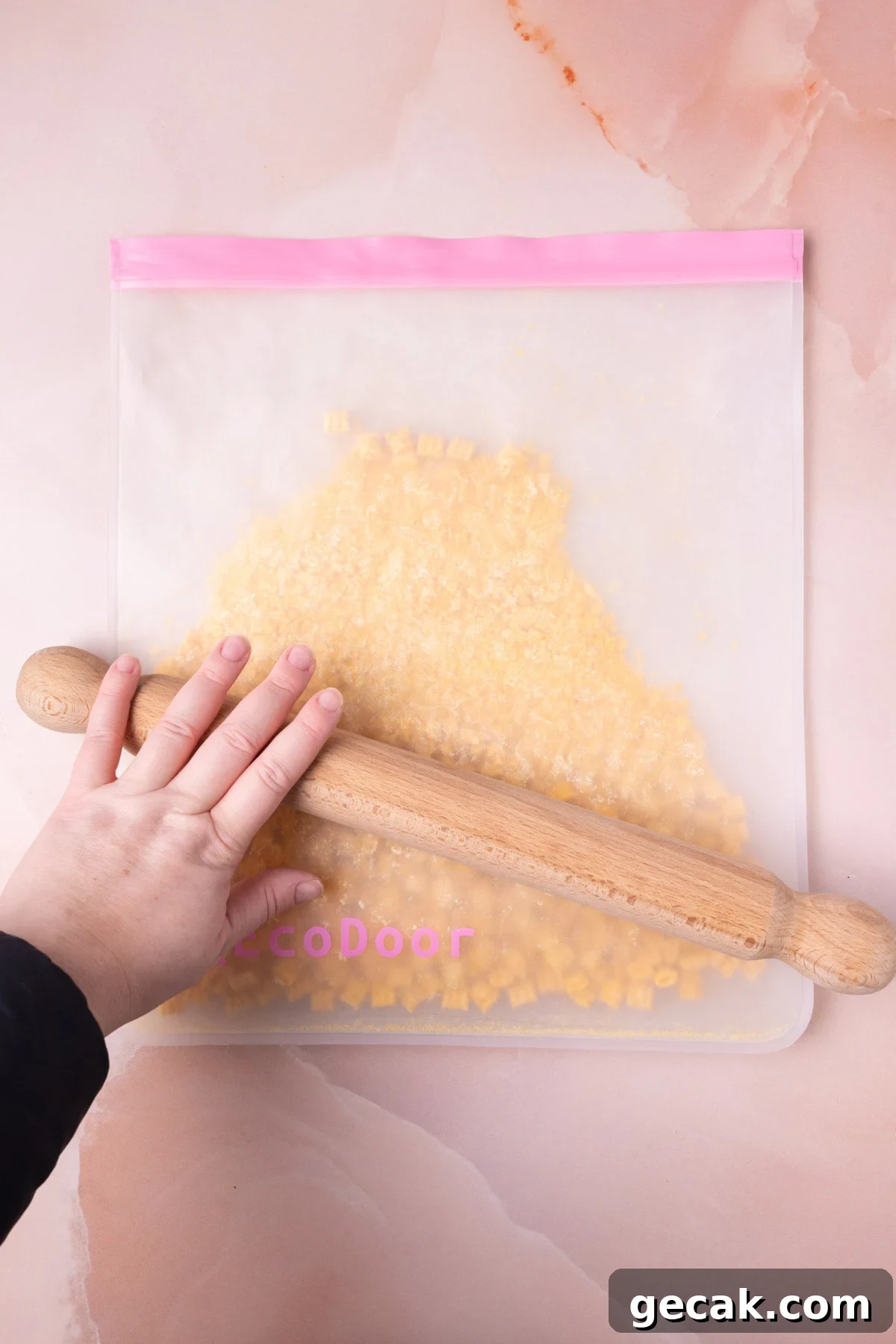 25-Minute Crunchy Cap'n Crunch French Toast Recipe 6 Using a rolling pin to crush cereal in a large reusable storage bag.