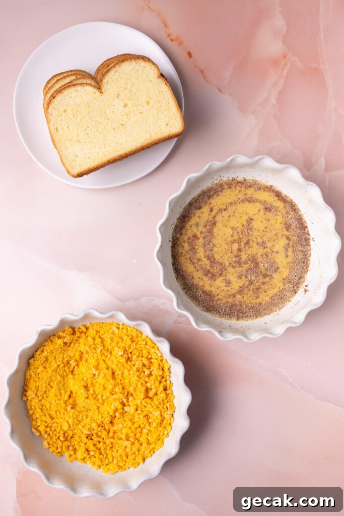 25-Minute Crunchy Cap'n Crunch French Toast Recipe 8 Bread, egg wash, and crushed Captain Crunch set up in an assembly line.