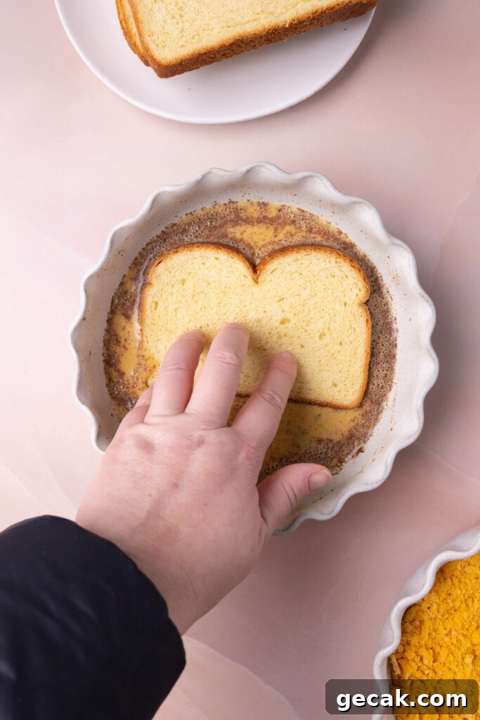 25-Minute Crunchy Cap'n Crunch French Toast Recipe 9 Dunking a slice of brioche into the egg wash.