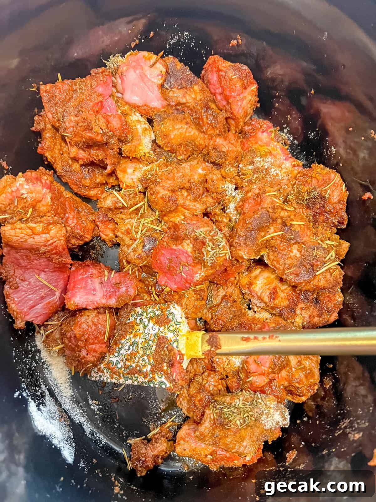 Seared meat in crockpot with coconut flour on top.