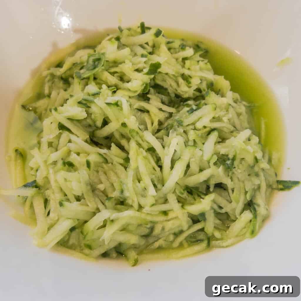Authentic Greek Tzatziki Sauce Recipe — How to Make It at Home 5 Step 2 Squeeze water out of salted grated cucumber