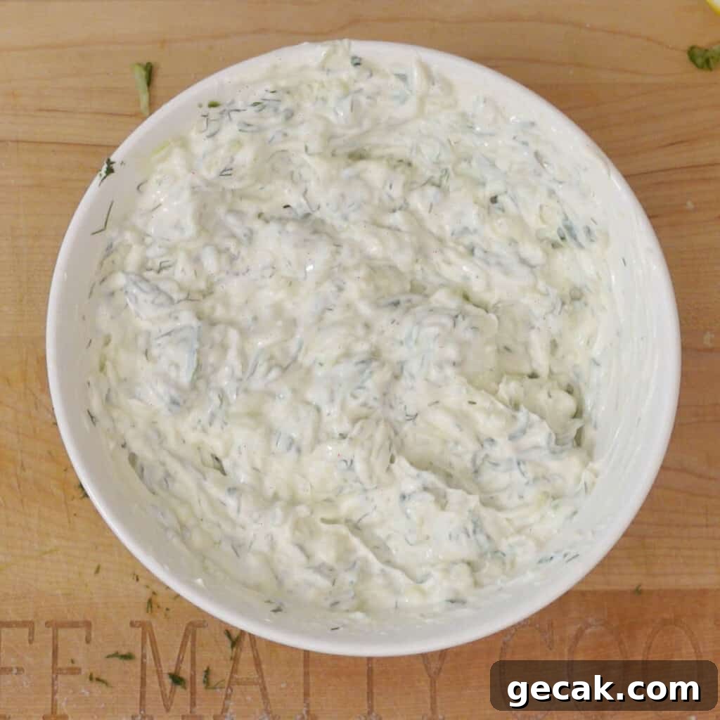 Authentic Greek Tzatziki Sauce Recipe — How to Make It at Home 6 Step 3 - mix yogurt into drained grated cucumbers in a bowl