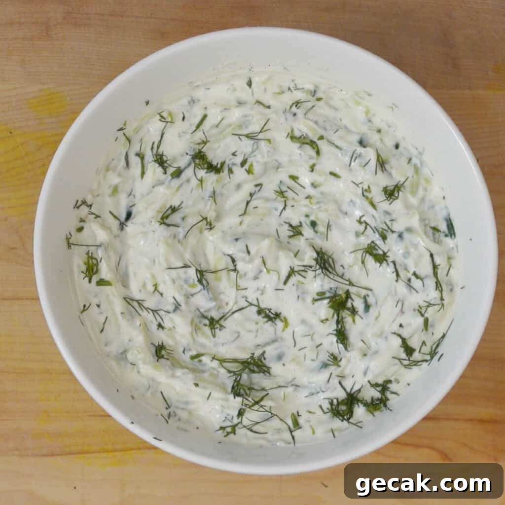 Authentic Greek Tzatziki Sauce Recipe — How to Make It at Home 7 Step 4 mix all ingredients in a bowl and top tzatziki sauce with dill