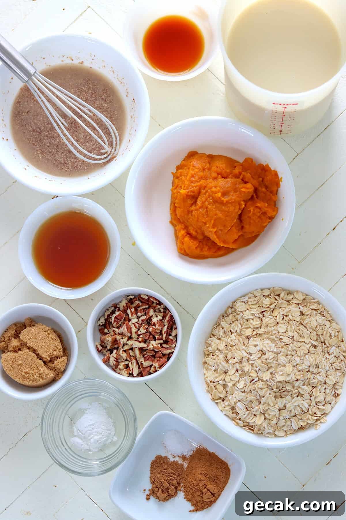 Ingredient needed for making pumpkin baked oatmeal on a white wooden board.