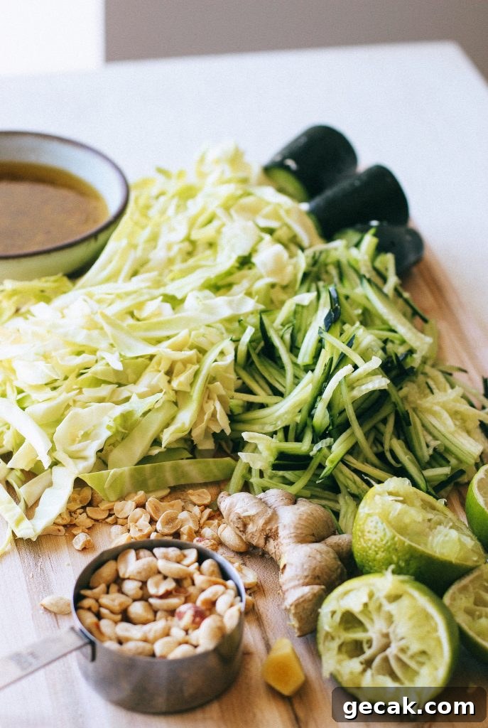 cabbage and cucumber salad ingredients on a wood cutting board