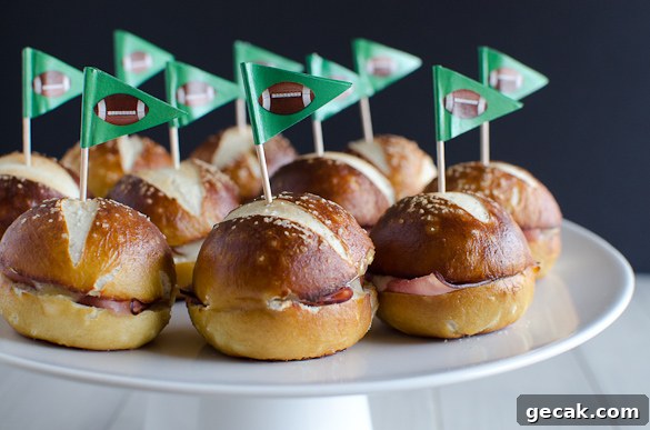 These Ham and Cheese Soft Pretzel Sliders are the perfect finger food for your tailgate party on game day. Everyone loves a good soft pretzel bun!