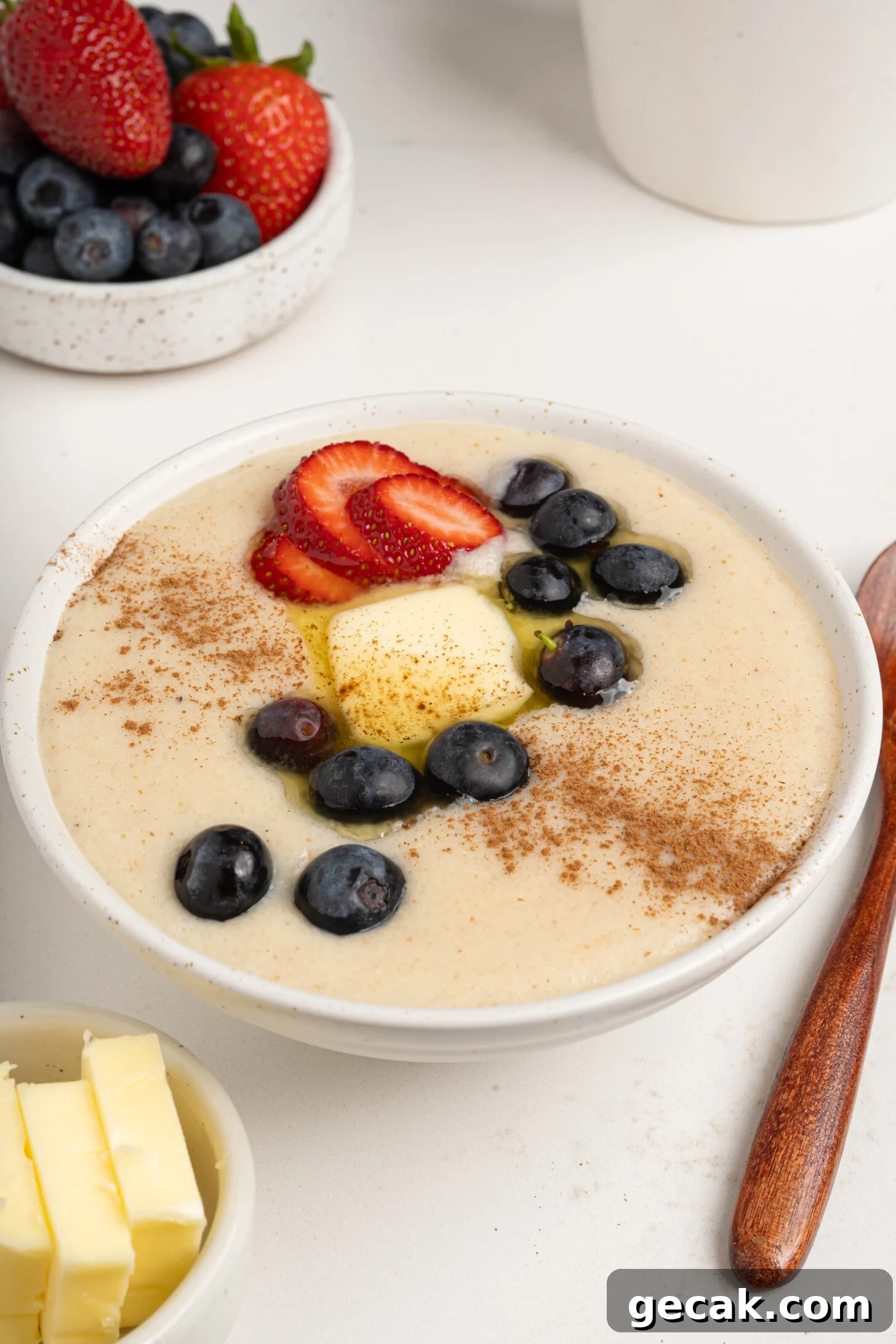 A bowl of farina with berries and butter.