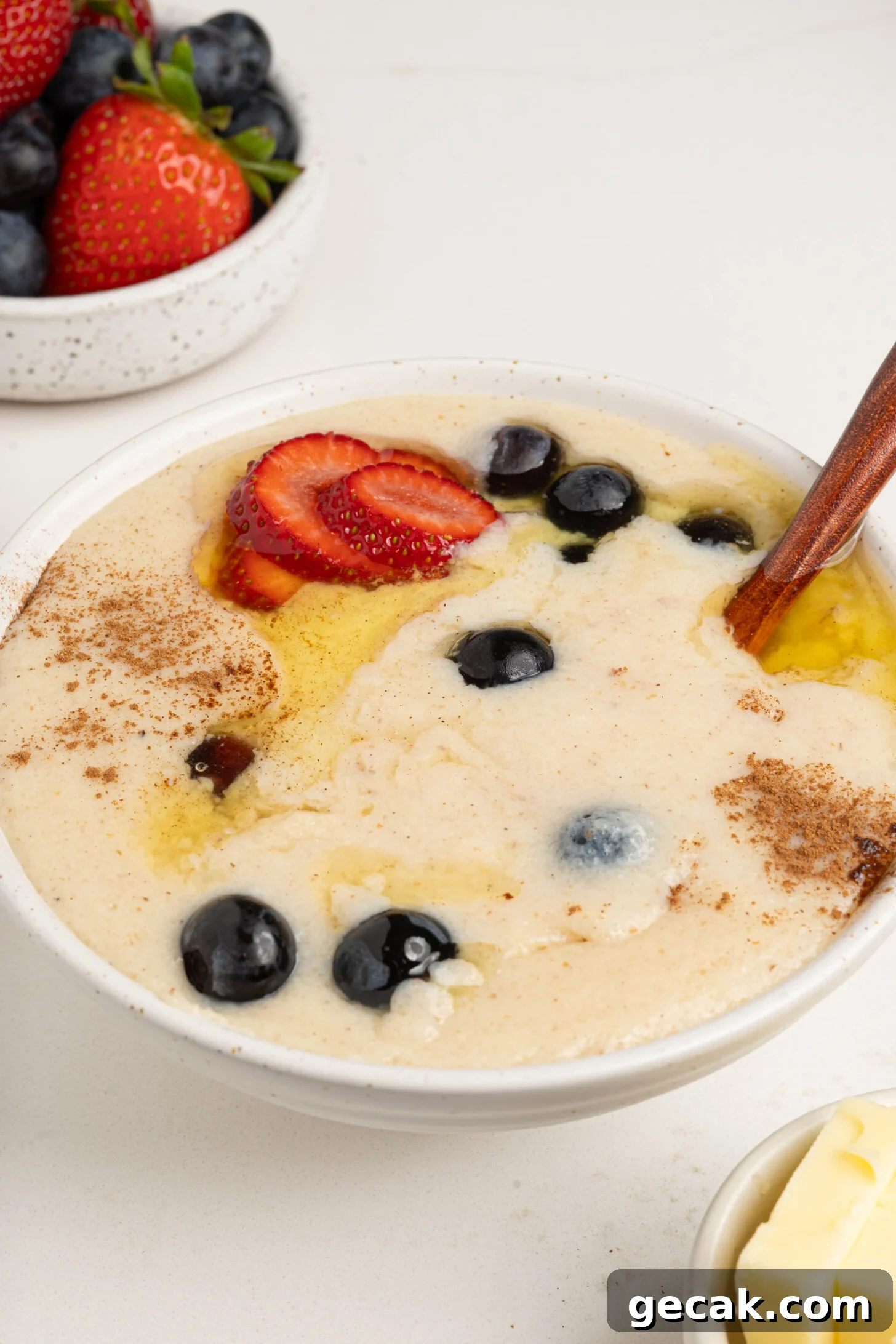 A bowl of farina with berries and butter.