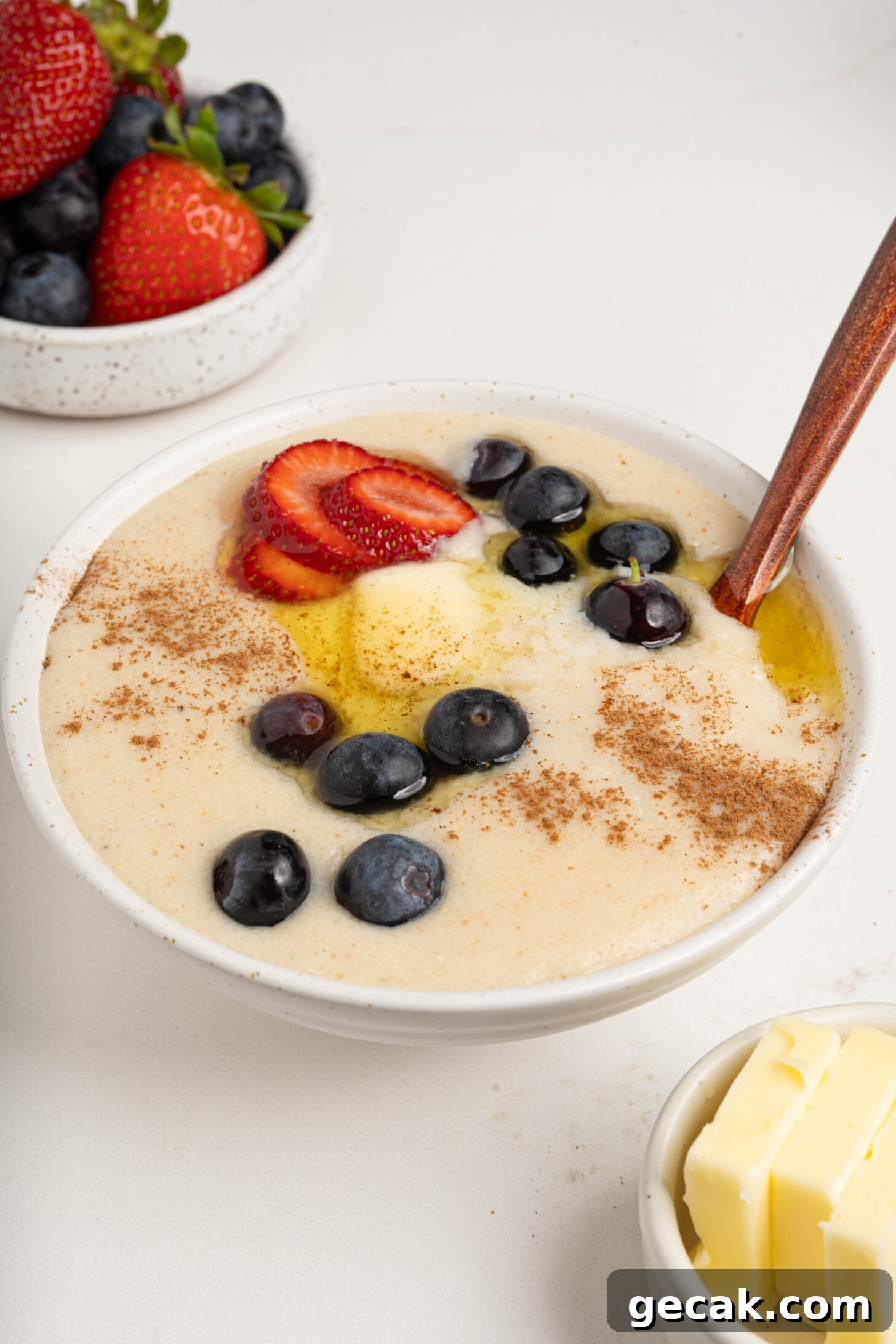 A bowl of farina with berries and butter.
