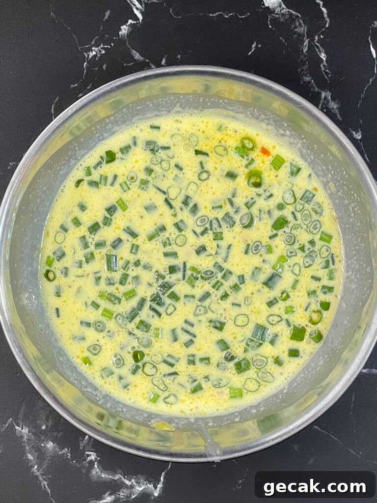 Southwestern Omelet Quiche Recipe – Flaky Crust & Savory Filling 11 Cooked bell peppers and green onions added to an egg mixture whisked together.