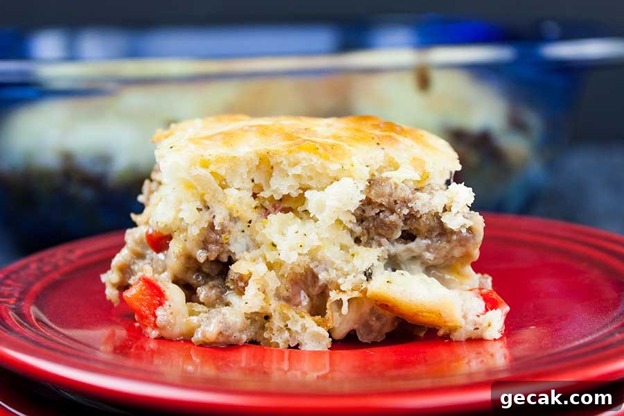 Sausage breakfast cake on a red plate.
