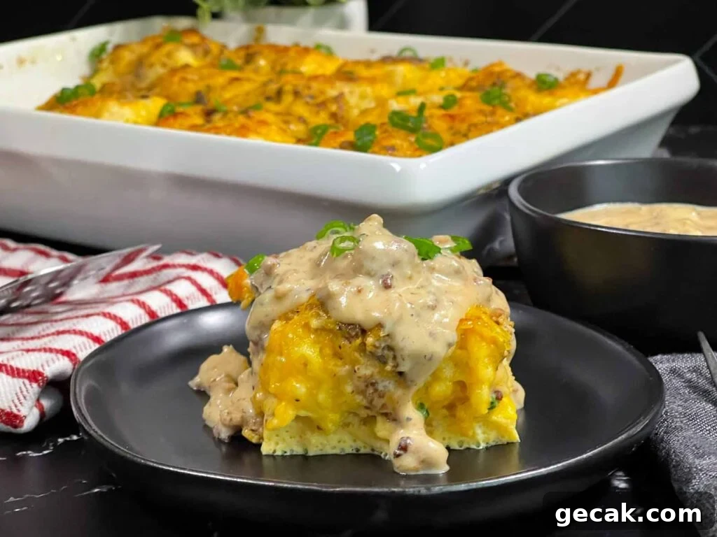 A serving of biscuits and gravy breakfast casserole on a dark plate.
