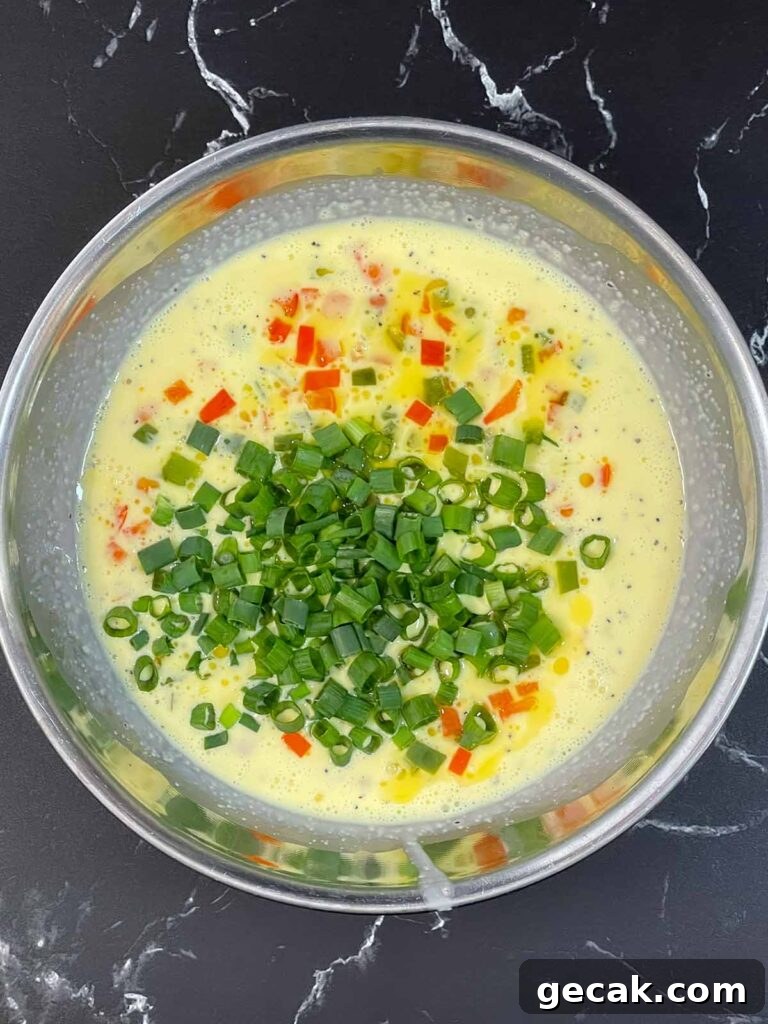 Southwestern Omelet Quiche Recipe – Flaky Crust & Savory Filling 10 Cooked bell peppers and green onions added to an egg mixture.