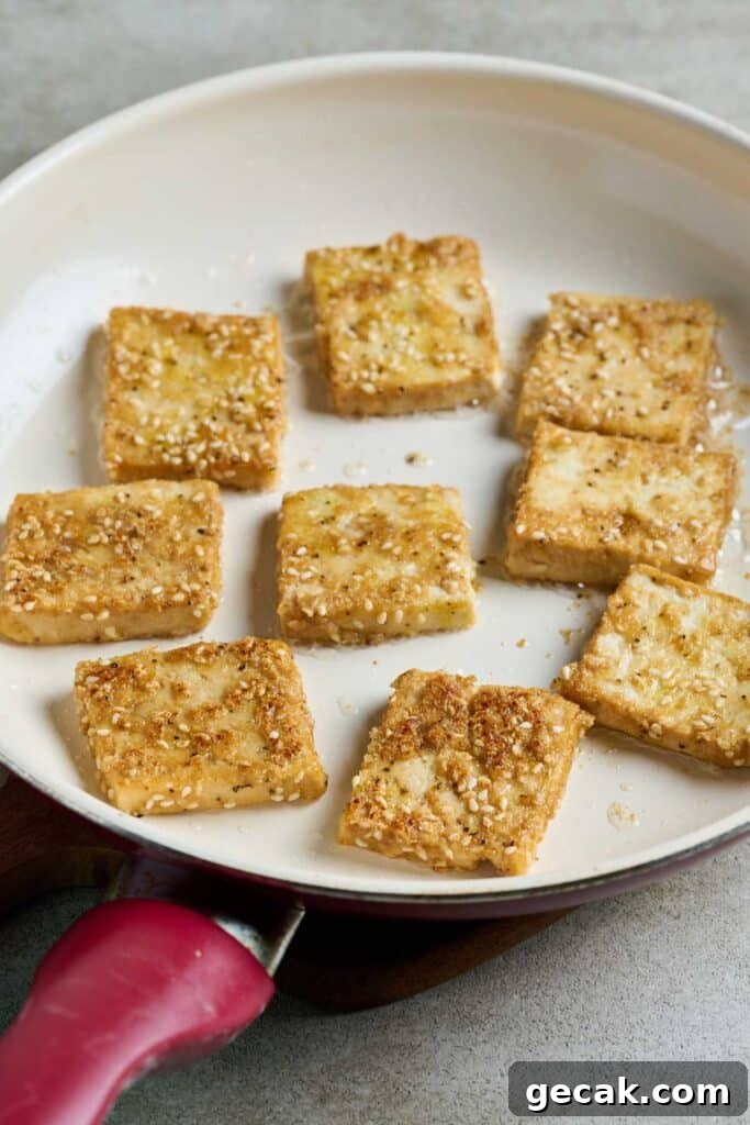 Pan frying tofu in a skillet