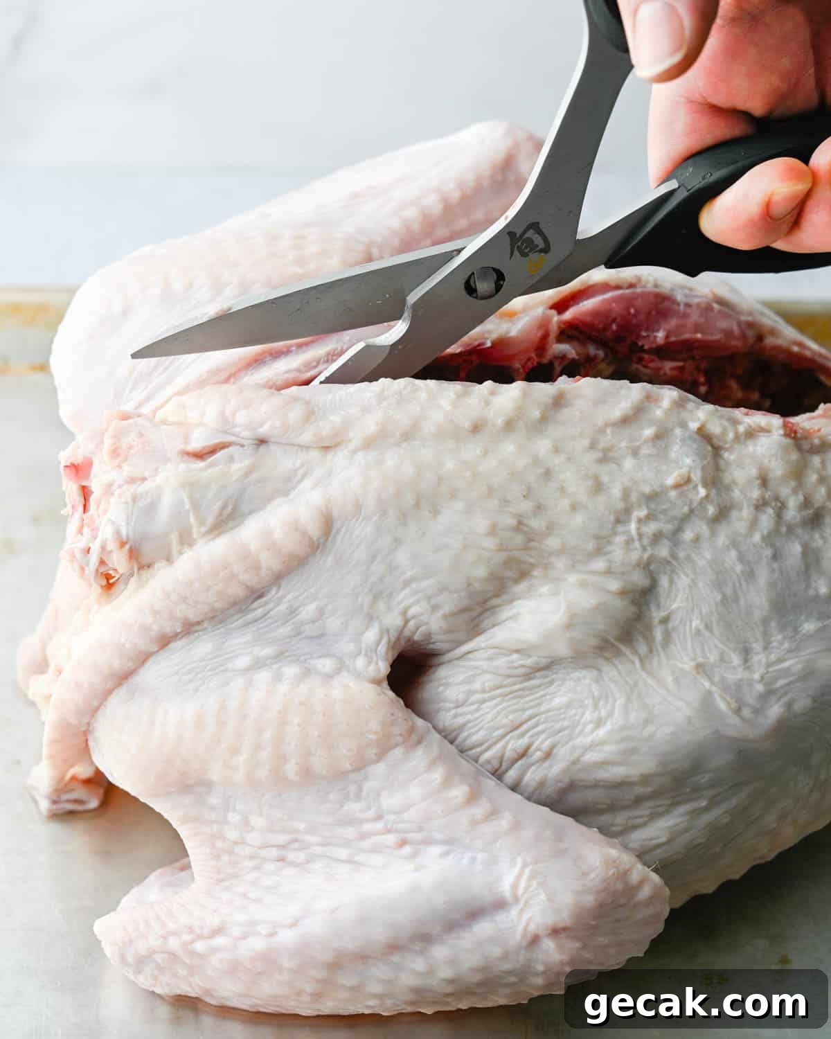 Removing the backbone from the turkey.