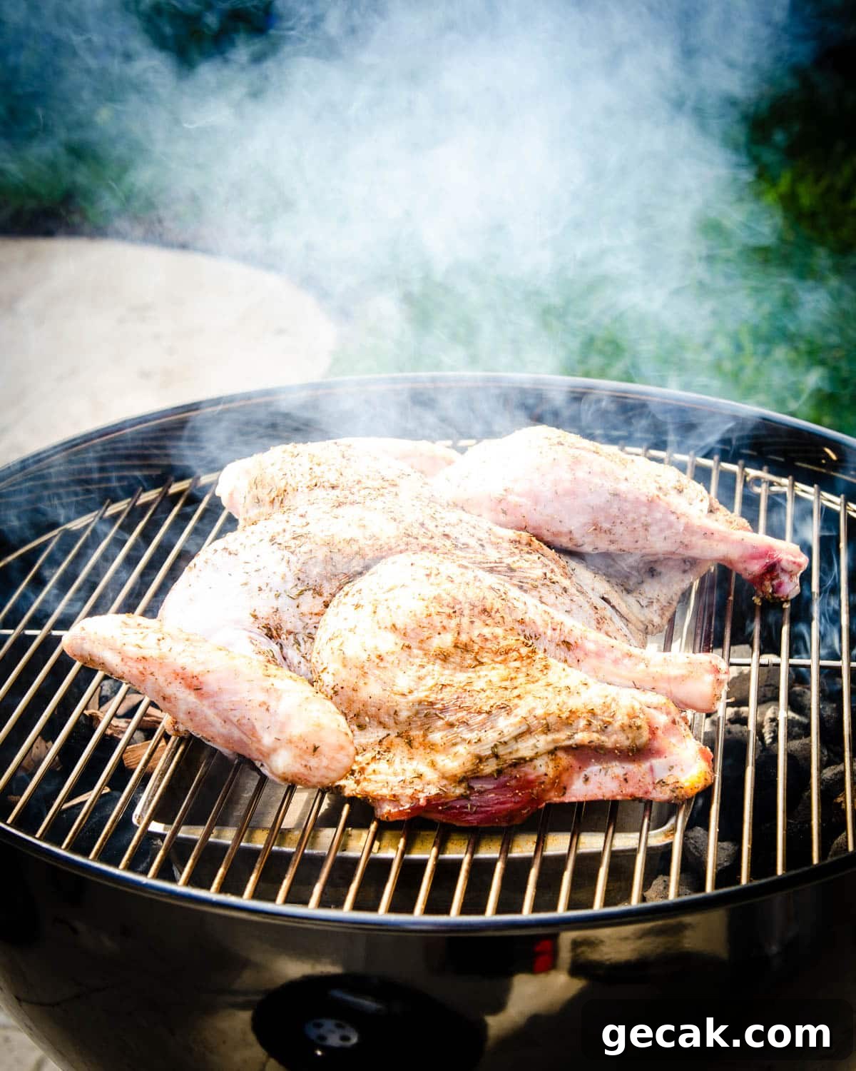 Placing the spatchcock turey on the grill.