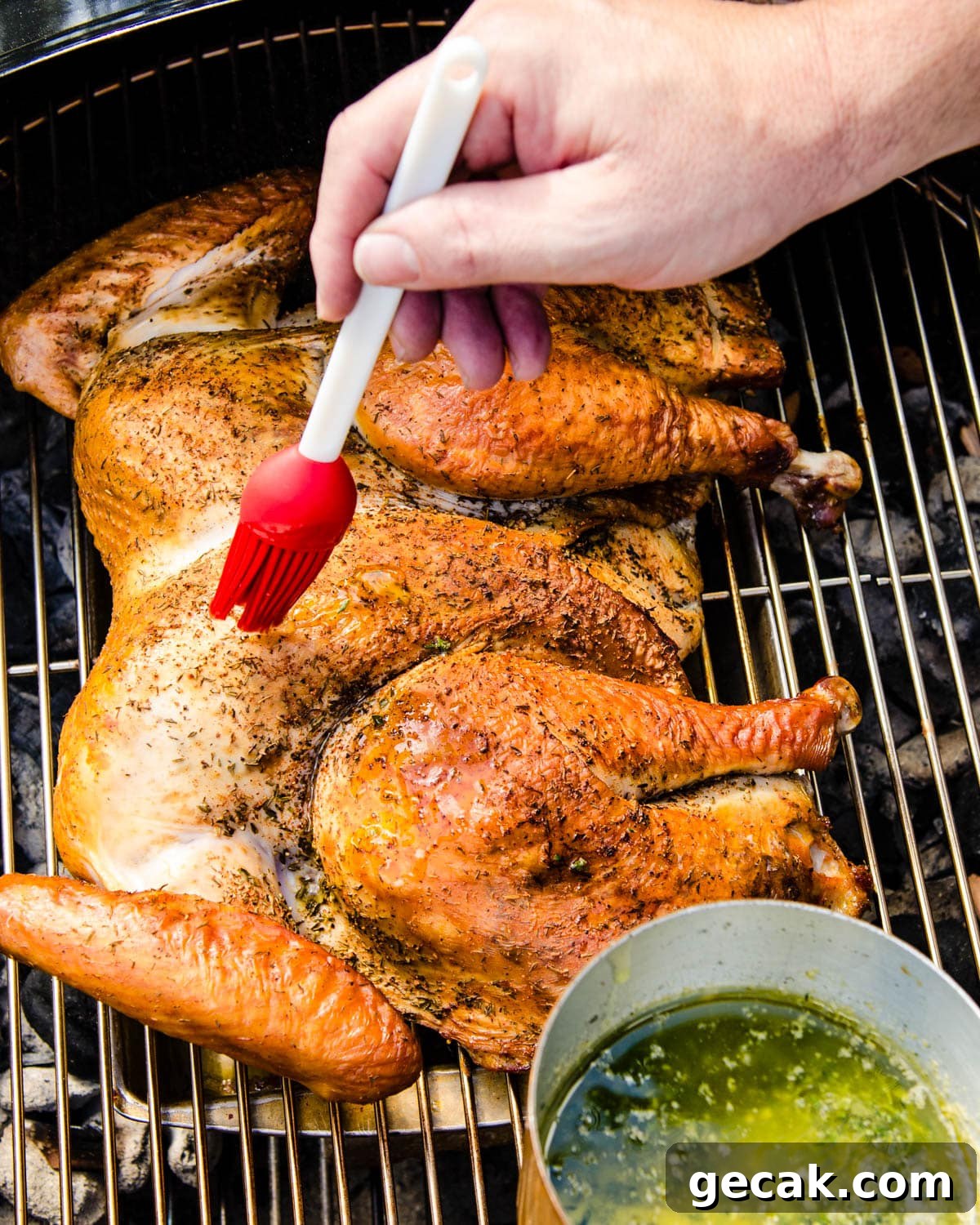 Basting the turkey with herb butter.