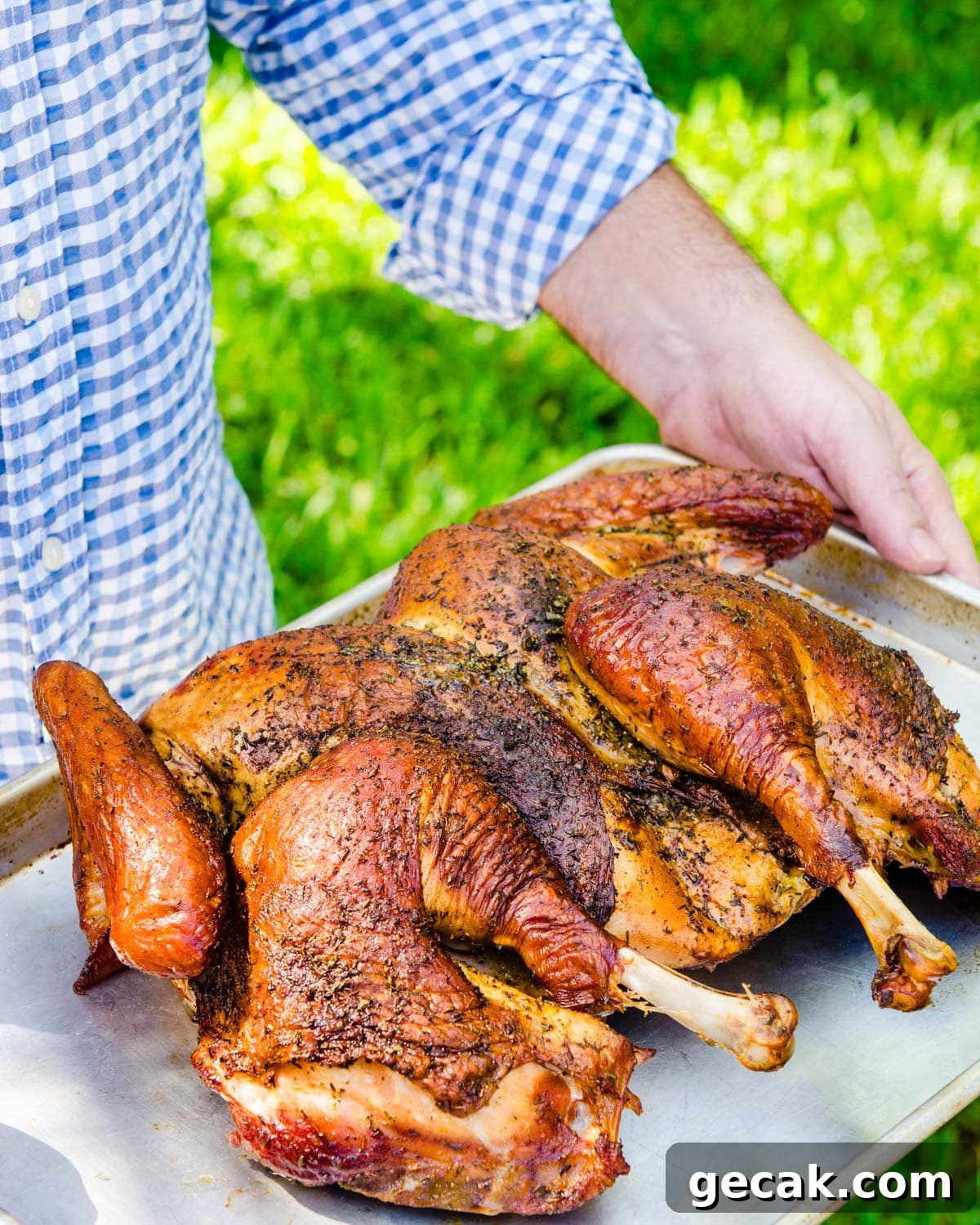 The finished spatchcock grilled turkey on a sheet pan.