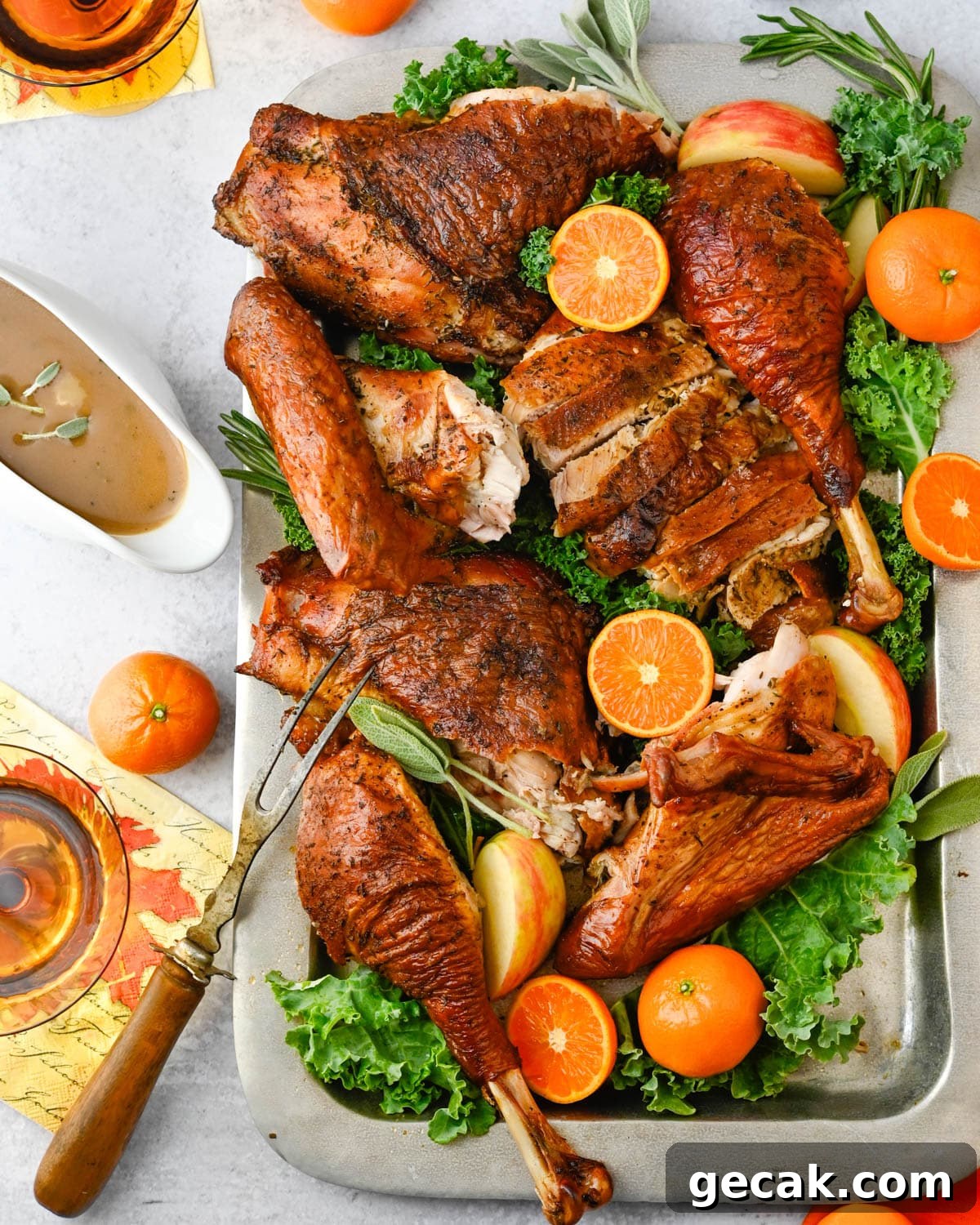 Serving the carved grilled turkey with gravy.